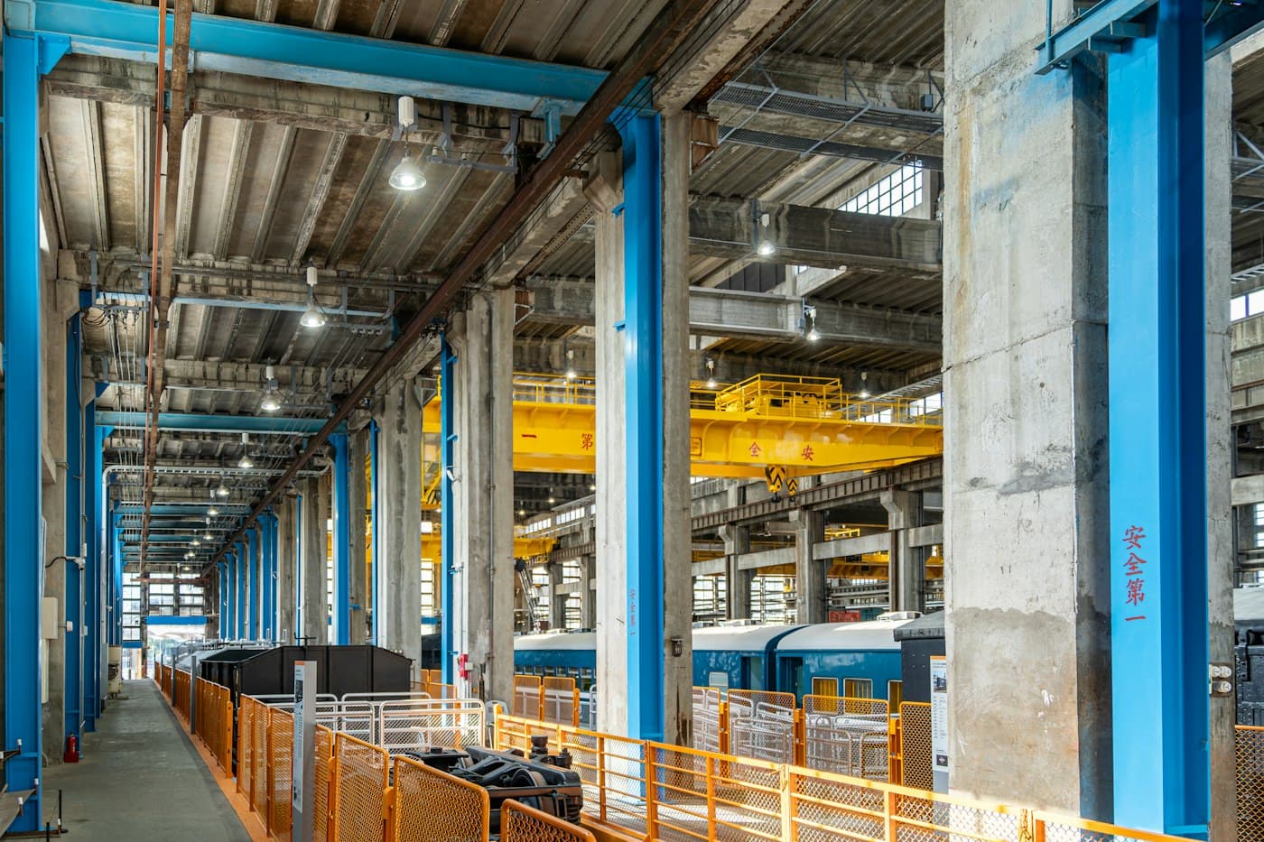 Large industrial facility interior with steel beams and crane